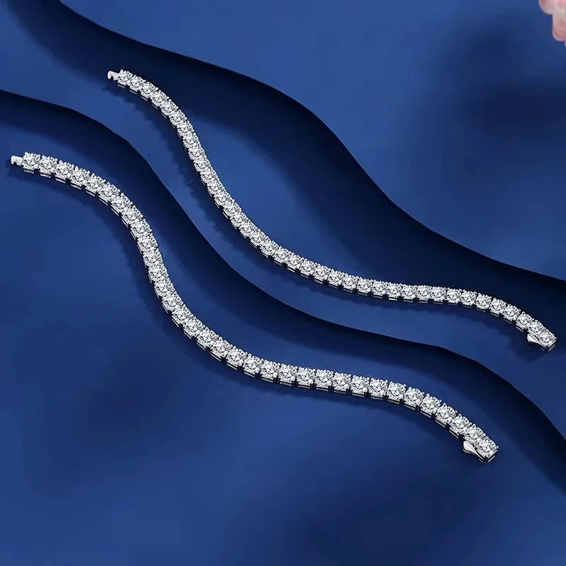 Silver bracelet with diamonds on a blue fabric background