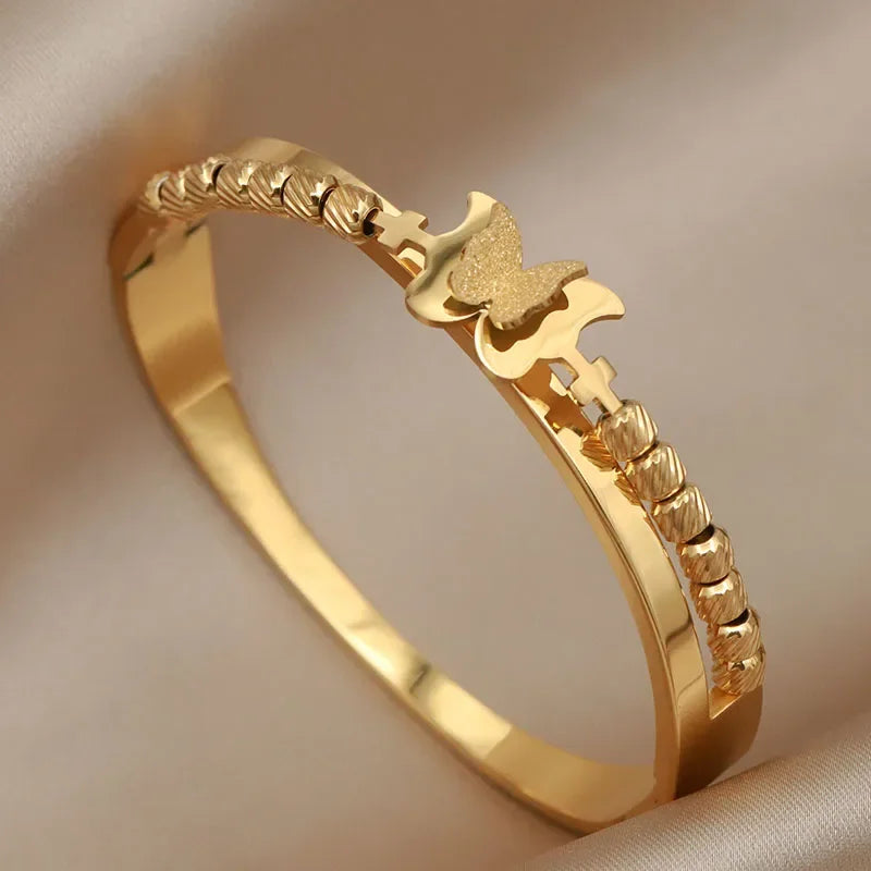 Gold ring with a decorative design on a beige background